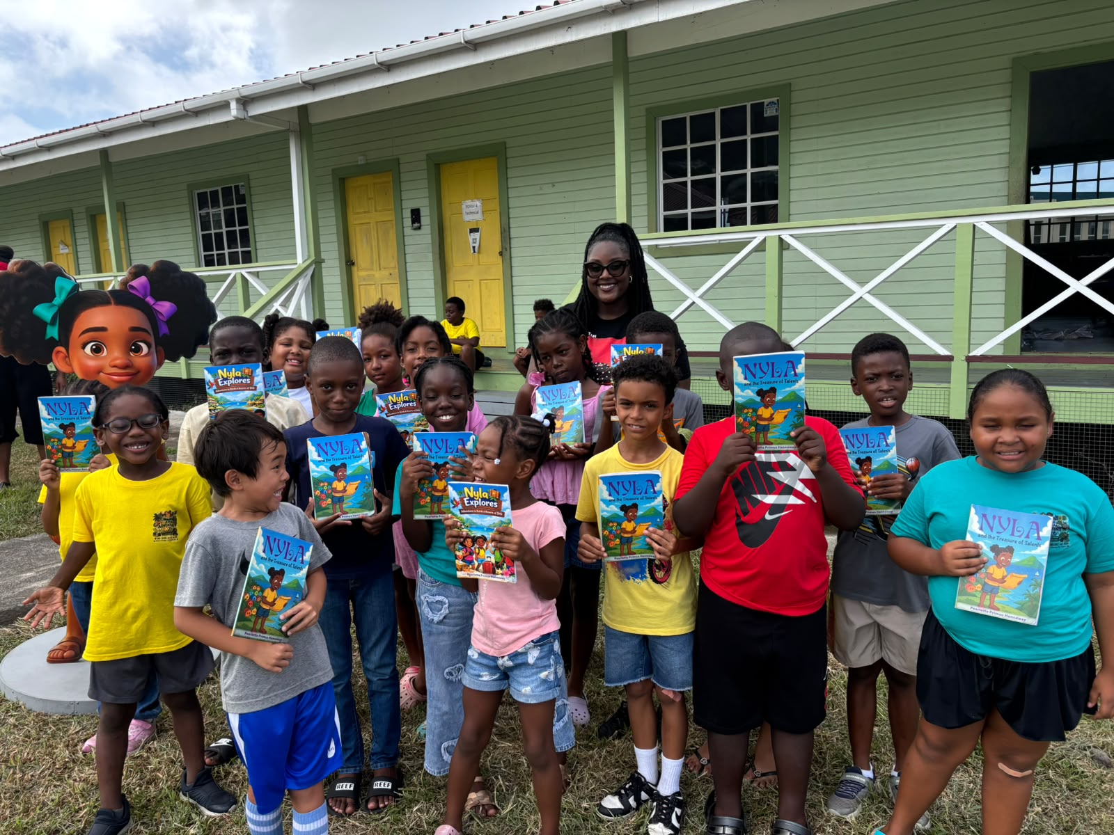 Reading Adventure Campers holding their Nyla the TVET Explorer books with Pearlette Primus Hannaway
